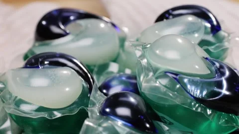 Laundry capsules for washing machine close-up. capsule contains concentrated Stock Footage 270186572