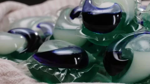 Laundry capsules for washing machine close-up. capsule contains concentrated Stock Footage 270186974