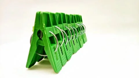 Laundry clips set, set of green plastic clothes pins or clothes pegs on white Stock Footage 304688551