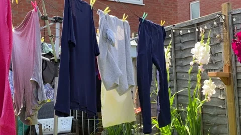Laundry clothes hanging out to dry in the hot sun Video stock 136954060