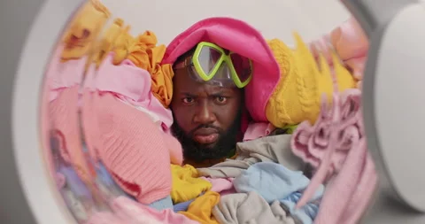 Laundry concept. Puzzled dark skinned bearded man poses against laundry sticks Stock Footage 156227030