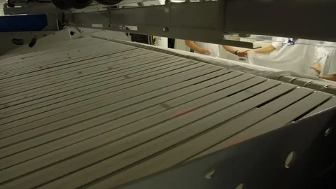 Laundry crew members inserting sheets in cruise ship laundry machine Video stock 117750958