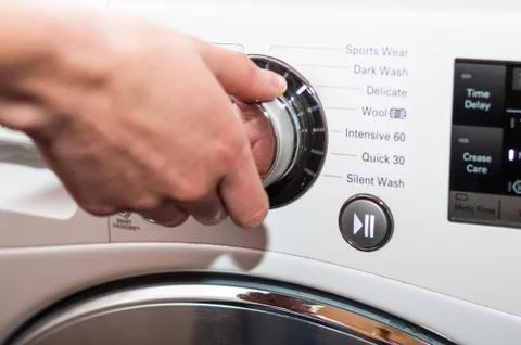 Laundry day - setting up washing machine program Stock Photos