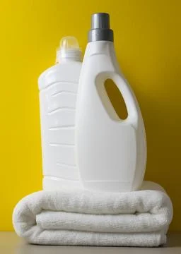 Laundry detergent bottles on color background, household cleaning concept Fotos de archivo