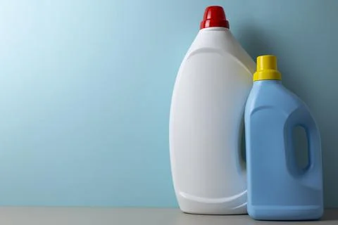 Laundry detergent bottles on color background, household cleaning concept Fotos de archivo