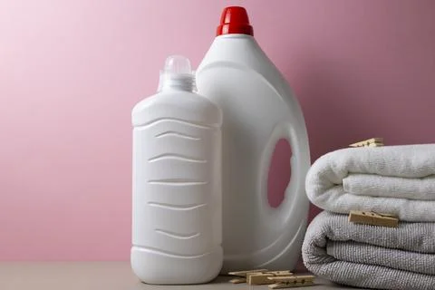 Laundry detergent bottles on color background, household cleaning concept Fotos de archivo