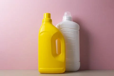 Laundry detergent bottles on color background, household cleaning concept Fotos de archivo