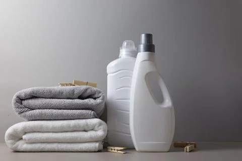 Laundry detergent bottles on color background, household cleaning concept Fotos de archivo
