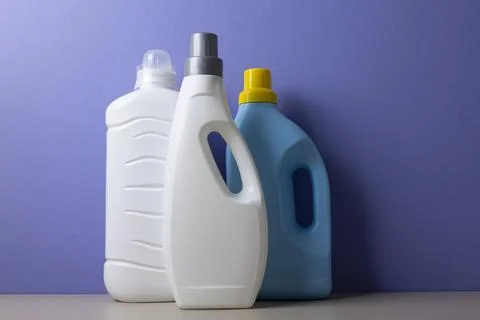 Laundry detergent bottles on color background, household cleaning concept Fotos de archivo