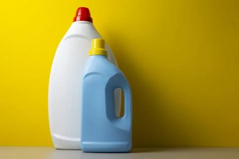 Laundry detergent bottles on color background, household cleaning concept Fotos de archivo
