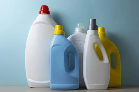 Laundry detergent bottles on color background, household cleaning concept Fotos de archivo