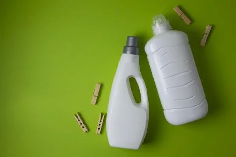 Laundry detergent bottles on color background, household cleaning concept 库存照片