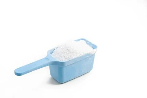 Laundry detergent, whashing powder in a plastic blue spoon Stock Photos