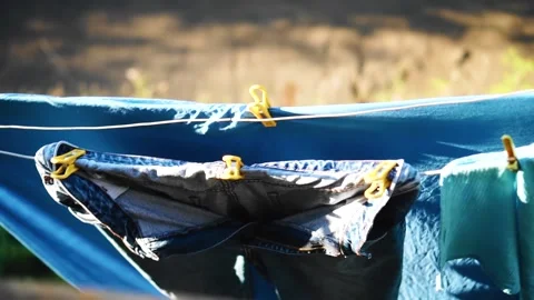 The laundry is dried on a rope and moved by the wind. View from above Stock Footage 136947646