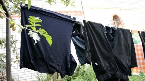 Laundry is dried on a rope. Wet Laundry hanging on ropes in the open air/ Stock Footage 138302448