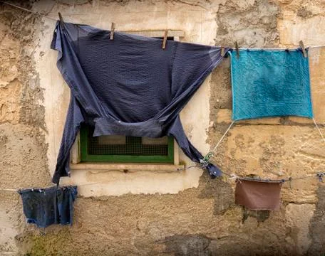 The laundry dries in front of the window. Stock Photos