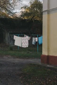 Laundry dries outside in the old Soviet courtyard. Clothes are drying outside Stock Photos