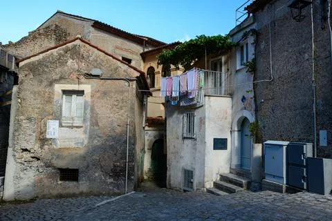 Laundry drying above old stone houses in Maratea Stock Photos