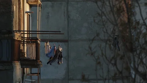 Laundry is drying and swaying in the wind, on the balconies of houses in the Video stock 180120016