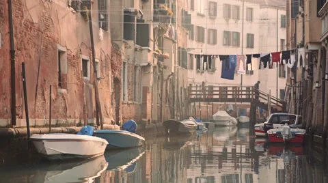 Laundry drying on clothesline above canal of Venice. Suspended bridge over canal Stock Footage 58899648