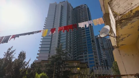 Laundry drying on clothesline in urban courtyard Видео 334759110