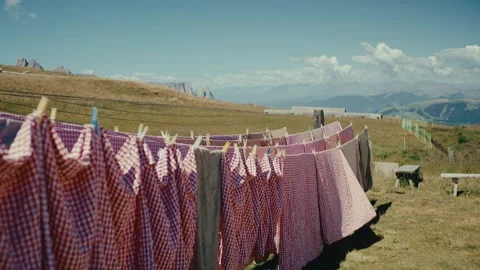 Laundry Drying on a Line Against a Scenic Mountain Landscape in Summer Stock Footage 331166120