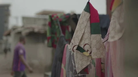 Laundry drying on lines in street with rack focus, Ivory Coast Stock Footage 333561539