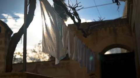 Laundry drying outside house in Matera on a sunny day Stock Footage 108734465