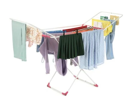 Laundry drying rack with various colorful clothes hanging to dry, household c Stock Photos