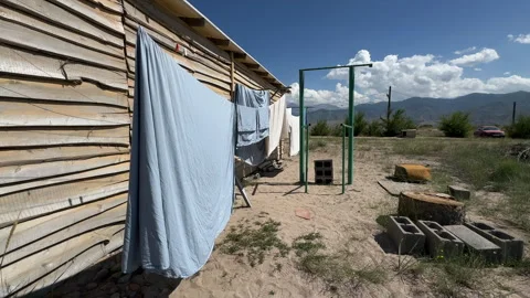 Laundry drying in a rural yard on Issyk-Kul south shore, Kyrgyzstan, 4K Stock Footage 342031369