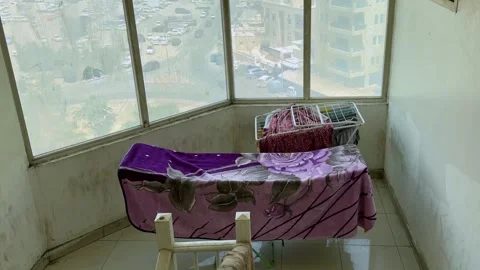 Laundry drying by stairwell window city view Stock Footage 336763543