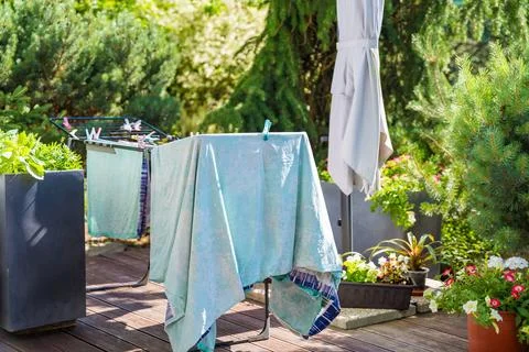 Laundry drying in a sunny garden Stock Photos