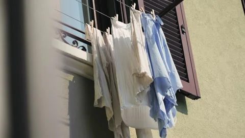 Laundry drying under the window. Authentic everyday street life in a historic Stock Footage 314424700