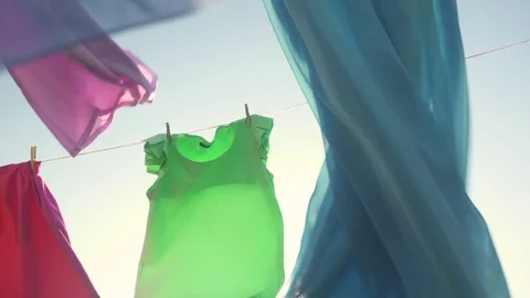 Laundry drying on washing line on sunny day Stock Footage