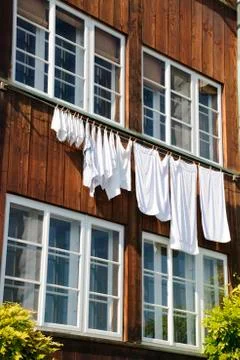 Laundry drying on window Stock Photos