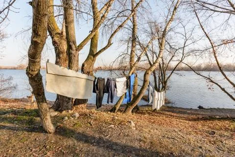 Laundry drying on a wire, under the mild winter sun, near the river 写真素材