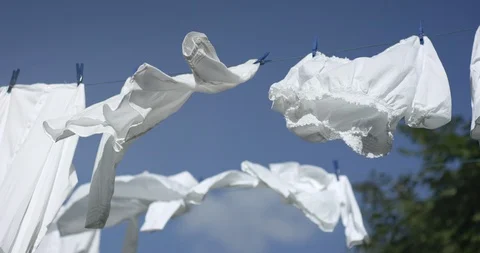 Laundry flapping on a clothesline ouside on a summer day Stock Footage 103324638