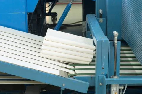 Laundry folded on ironing machine Stock Photos