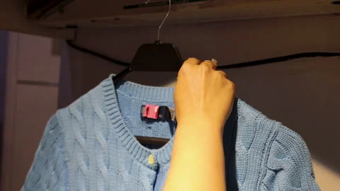 Laundry, hand hanging finished clothes for packing Stock Footage 283808210