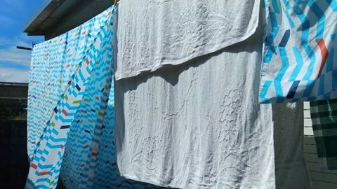 Laundry hanging on clothesline Stock Footage 159982246