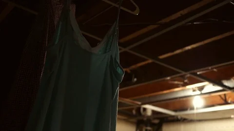 Laundry hanging in dark unfinished basement via broken dryer situation Video stock 81110593