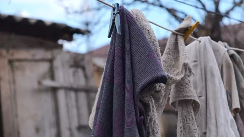 Laundry hanging outside to dry. Drying rags on the clothesline. Dirty rags Stock Footage 126650140