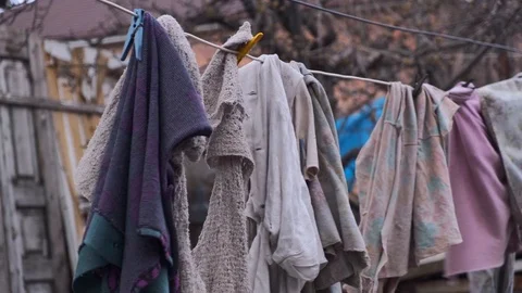 Laundry hanging outside to dry. Drying rags on the clothesline. Dirty rags Stock Footage 126650157