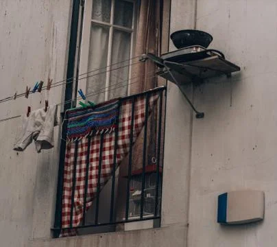 Laundry hanging outside the window on lines in Portugal, Lisbon Stock Photos