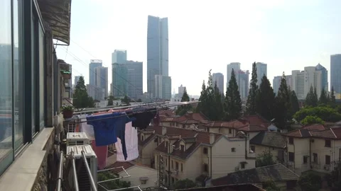 Laundry hanging on the window of a balcony in the city center, China Stock Footage 159649901