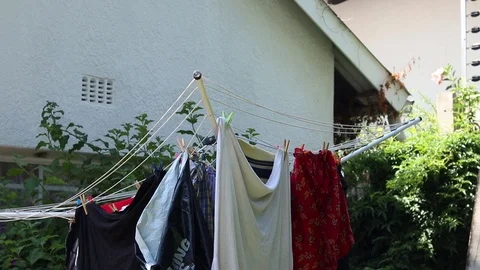 Laundry on the line in the back garden Stock Footage 124697931