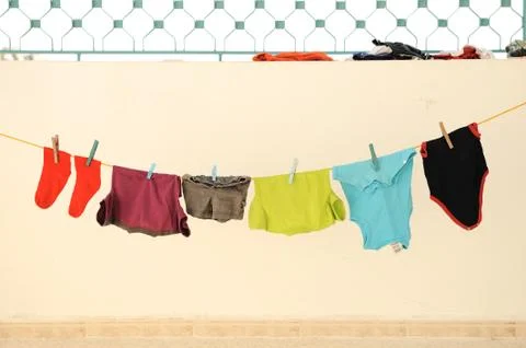Laundry line with clothes on a sandy backround Foto stock