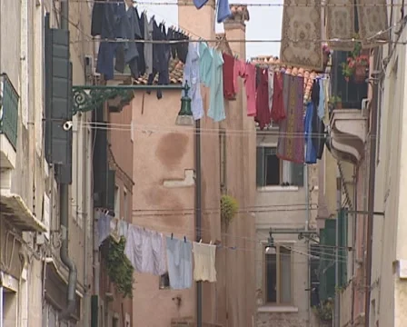Laundry lines between the facades of row houses in a narrow lane, Venice Stock Footage 56305044