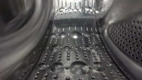 Laundry machine, inside process. Water splashing in the washing machine. Stock Footage 151088728