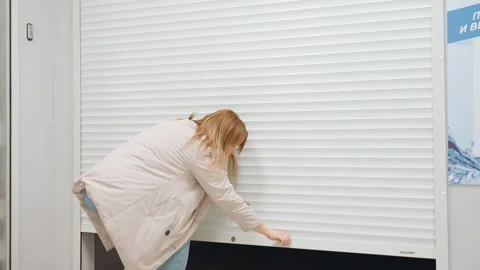 Laundry Manager Closing Rolling Shutter At Shop Entrance Stock Footage 318848497